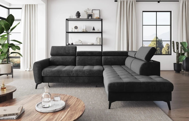 BJORN L Corner Sofa Bed in modern living room setting, featuring black velour fabric, quilted seats, adjustable headrests, and metal legs.