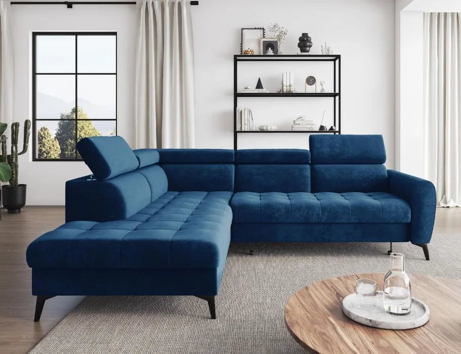BJORN L corner sofa bed in blue velour fabric with adjustable headrests and metal legs, set in a modern living room.