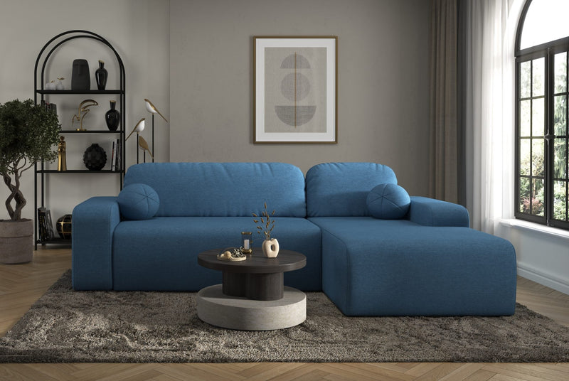 Modern blue Tori Corner Sofa with cloud fabric upholstery and decorative cushions in a bright living room