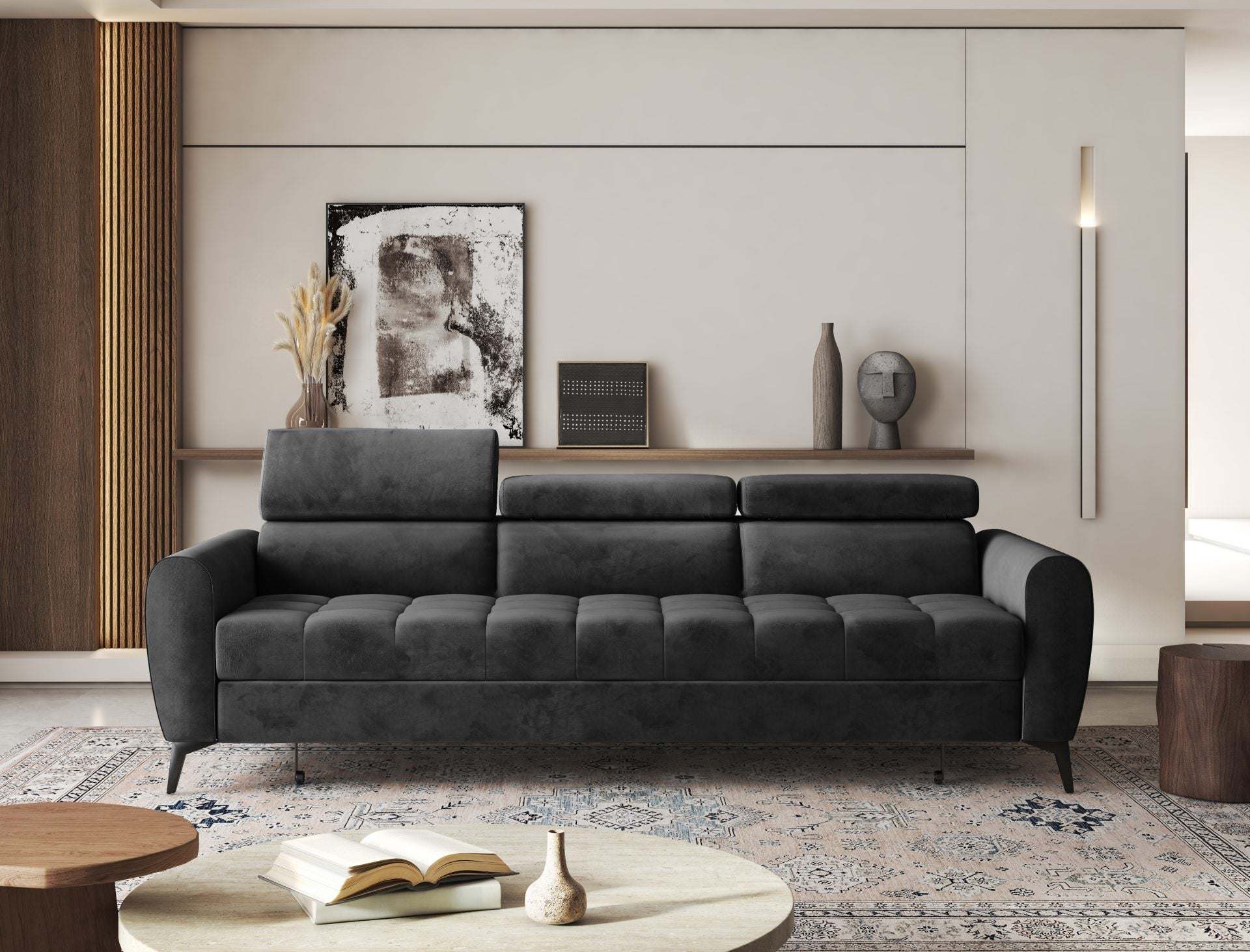 BJORN Sofa Bed in dark fabric with adjustable headrests, in a modern living room setting.