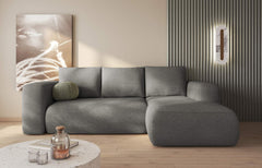 LAMBI corner sofa bed in grey fabric in modern living room setting.