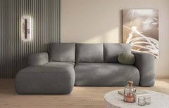 LAMBI Corner Sofa Bed in modern living room with multicoloured fabric, seating for three, convertible to bed.